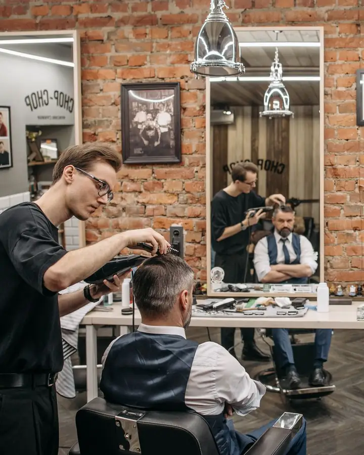 A barber cutting a customer's hair