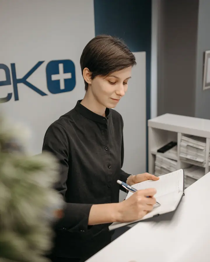 A receptionist at a clinic front desk