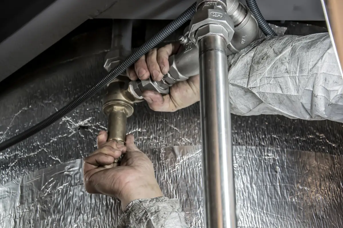 A plumber fitting pipes